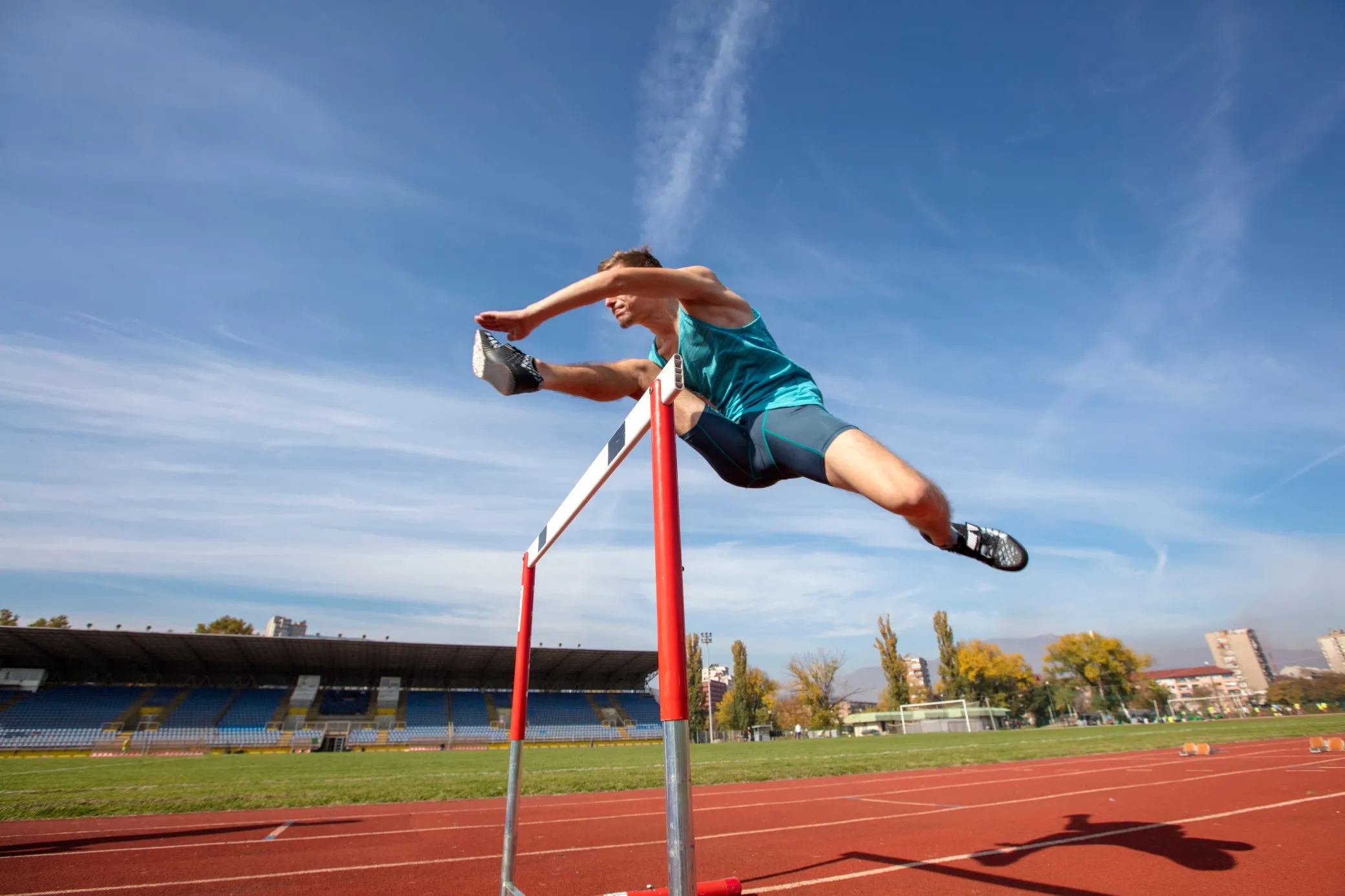 Athlete jumping a hurdle